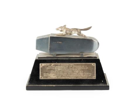 A silver presentation model of a running fox, upon an ingot, by Gladwin Ltd, Sheffield 1954, the ebonised plinth base with si