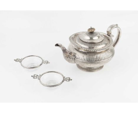 A William IV silver teapot, with lobed and gadrooned decoration, and foliate capped reeded handle, ivory finial and insulator
