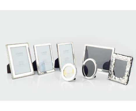 A silver rectangular photograph frame, with ropetwist border, 18.5 x 13.5cm, another similar slightly smaller frame, and five