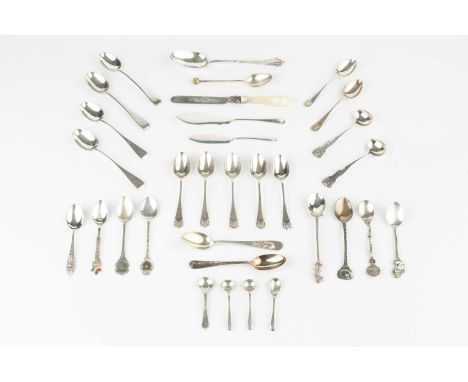 A collection of assorted silver flatware, mainly teaspoons, souvenir spoons etc, and a silver knife with mother o'pearl handl