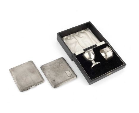 Two silver cigarette cases, with engine turned decoration, London 1927 and Chester 1935, together with a silver egg cup on we