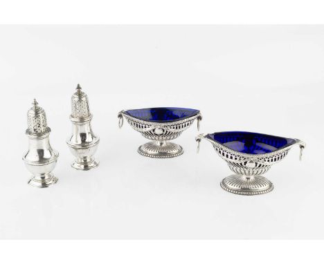A pair of late Victorian silver twin handled pedestal salts, of neo-classical pierce-decorated form, with blue glass liners, 