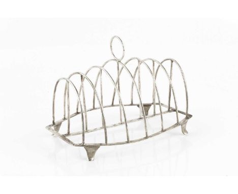 A George III silver seven bar toast rack, of arched wirework form, on shaped feet by Stephen Adams II, London 1808, 15.5cm lo