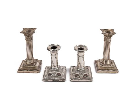 A pair of Edwardian silver candlesticks, with reeded columns, corinthian capitals and gadrooned square weighted bases, by Wil