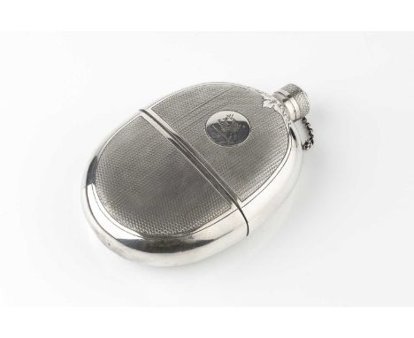A Victorian silver plated oval hip flask, with engine turned decoration reserving a circular engraved crest, 15cm high