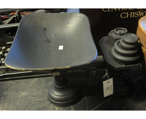 Set of black painted shop scales with painted copper pan and various black painted weights.