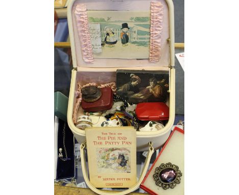 Jewellery suitcase containing assorted costume and dress jewellery; beads; brooches; china souvenir miniature planters; trink