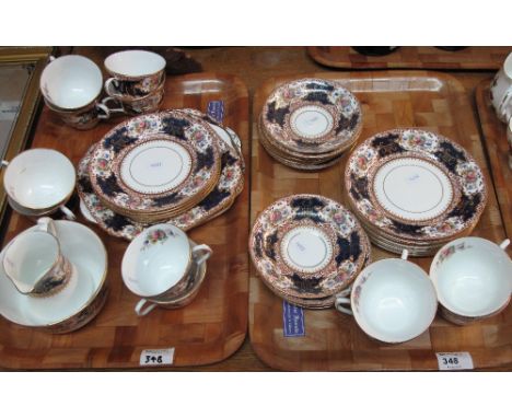 Two trays of Staffordshire 'Bon' teaware on a white ground with gilt, cobalt blue and floral decoration comprising: tea cups;