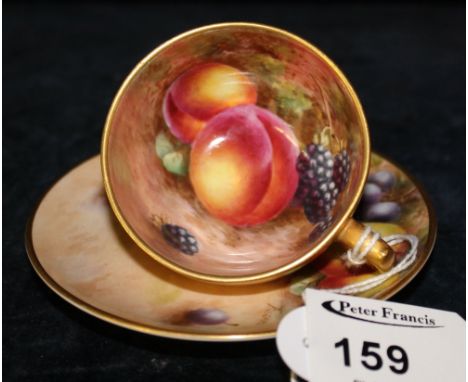 Royal Worcester bone china cabinet cup and saucer, hand painted with fruit within gilt border, signed: Freeman, black transfe