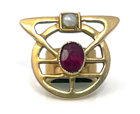 A Dutch Secessionist 14 carat gold, ruby and split pearl scarf ring, VA, circa 1905, the geometric frame of interlocking circ