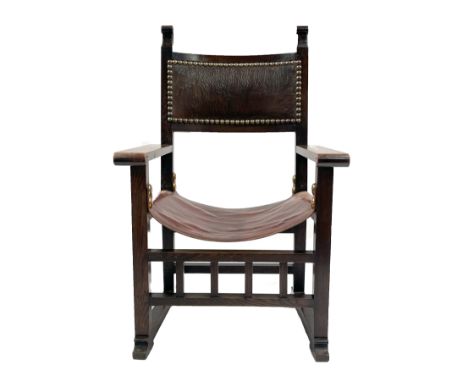 Liberty and Co., an Arts and Crafts oak Spanish Throne armchair, attributed to Leonard Wyburd, studded panel back with square