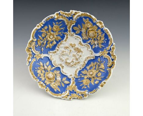 An early 20th century Meissen Leuteritz rococo relief moulded plate, circular dished form, decorated with floral sprays withi