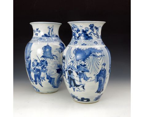 A pair of Chinese blue and white baluster vases, the openings with birds and insects amongst foliage, the friezes with proces