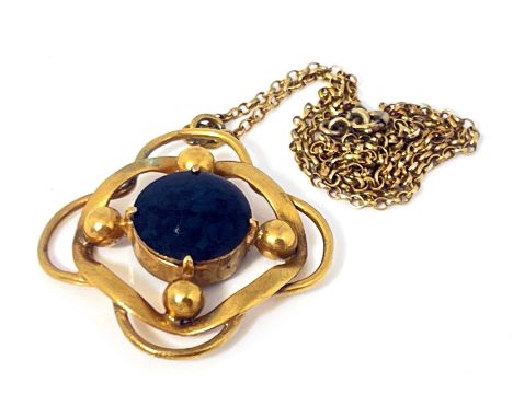 An Arts and Crafts yellow metal and enamelled pendant, circa 1910, the central green enamel granite effect roundel within an 