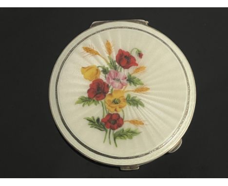 An Elizabeth II silver powder compact, Turner &amp; Simpson Ltd, Birmingham 1962, circular guilloche enamel cover with a spra