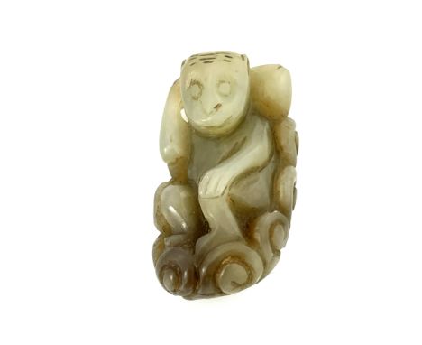 A Chinese pale and brown tinted jade carving, monkey with a large gourd, 5cm long 