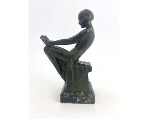 Max Le Verrier, an Art Deco patinated art metal figural bookend, circa 1925, modelled as a nude woman reading a book, sitting