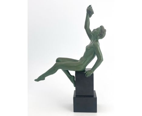 Max Le Verrier, an Art Deco patinated art metal figure, circa 1925, modelled as a nude woman holding a bunch of grapes, recli