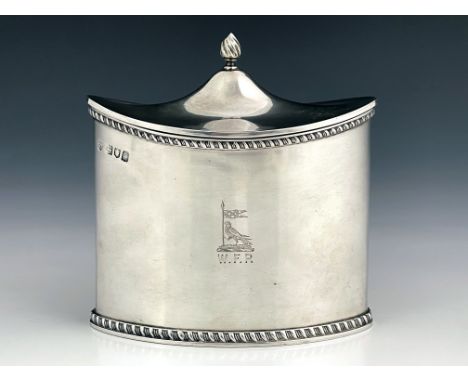 An Edwardian silver tea caddy of military interest, Haseler Brothers, London 1902, of oval form, hinged caddy top with finial
