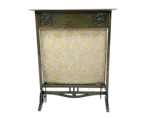 Arthur Simpson of Kendal, an Arts and Crafts green stained fire screen, the frieze carved with two fruiting foliate panels, a
