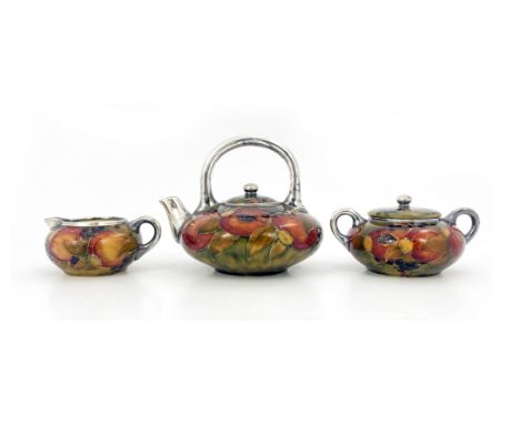 William Moorcroft for Shreve and Co., a silver overly Pomegranate tea set, 1911, squat ovoid form with silvered handles and s