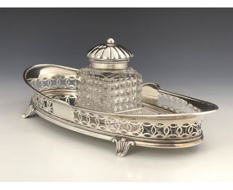 An American sterling silver ink stand, Gorham, circa 1905, the oval tray with reticulated gallery, on four lily bracket feet,