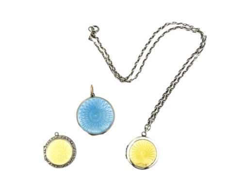 Three silver and enamelled locket pendants, including two with yellow guilloche enamel lids, the third in silver gilt, both s