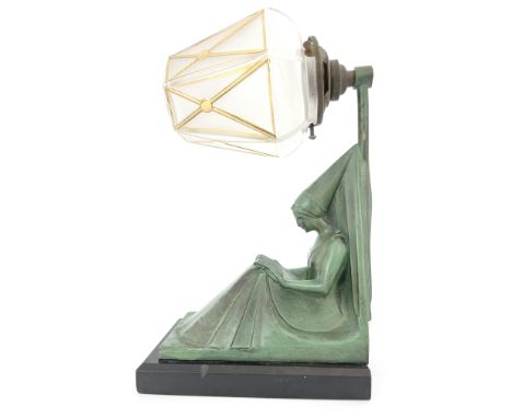 Max Le Verrier, an Art Deco patinated art metal figural bracket light, circa 1925, modelled as a Medieval lady reading, with 