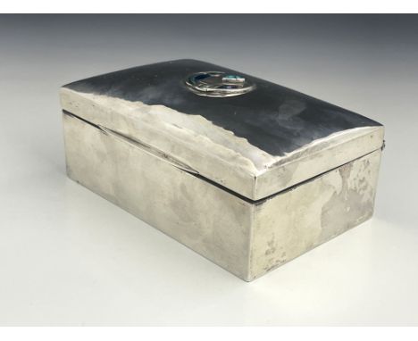 Archibald Knox for Liberty and Co., an Arts and Crafts silver and enamelled cigar box, Birmingham 1923, planished and cushion