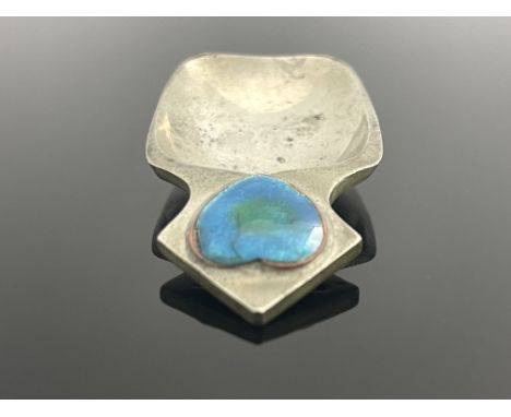 Liberty and Co., an Arts and Crafts Tudric pewter and enamelled caddy spoon, model 01095, the shovel bowl with triangular han