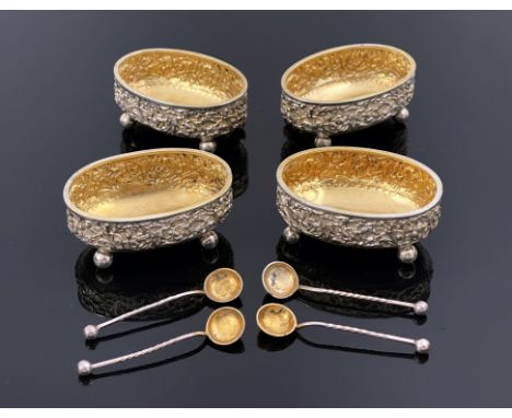 A set of four Victorian silver and parcel gilt salt cellars and spoons, Nathan and Hayes, Birmingham 1891, oval basin form em