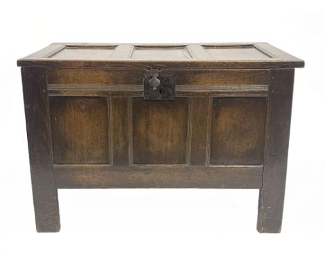A late 17th Century oak chest, triple panel top with wire hinges, blacksmith lock, triple panel front, raised on stiles, 67cm