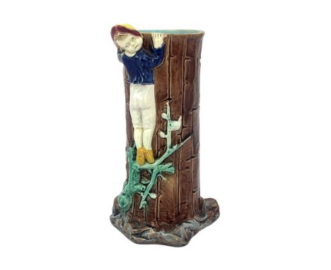 A Majolica figural spill vase, circa 1870, modelled as a boy climbing a tree trunk, unmarked, 18cm high