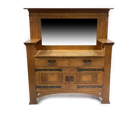 An Arts and Crafts oak mirror back sideboard, in the manner of Harris Lebus, the base with two drawers over two linenfold car