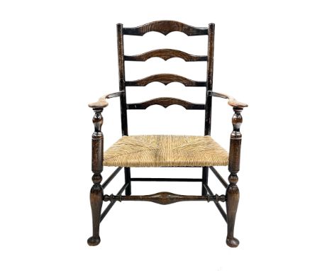 Edwin Lutyens, an Arts and Crafts rush seated ladder back armchair, four graduated ogee cut yolk cross splats, on turned balu