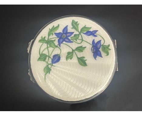An Elizabeth II silver powder compact, circular with guilloche enamel violets on a cream ground to the cover, 2.83ozt
