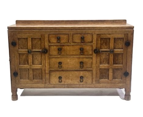 Robert Mouseman Thompson of Kilburn, an oak panelled sideboard, mid 20th Century, adzed throughout, raised back rail, two sho