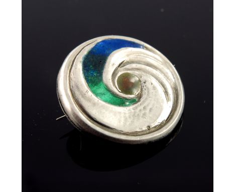 Archibald Knox for Liberty and Co., an Arts and Crafts Cymric silver and enamelled brooch, Birmingham 1904, circular coiled b