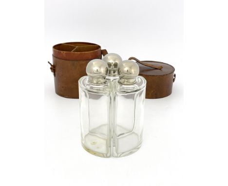 Sporting Interest, a George V giant triple flask set, clear cut glass segment bottles with electroplated bulbous screw tops, 