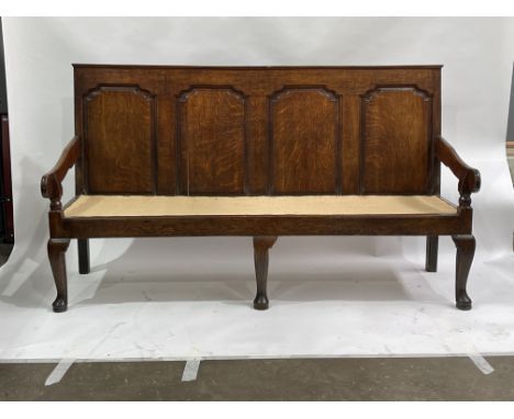 A George III country oak hall settle, circa 1770, four fielded panel back, downswept arms, cabriole legs, pad feet, 105cm hig