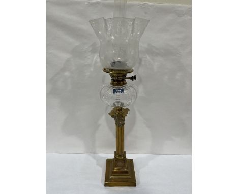A Victorian brass corinthian base duplex oil lamp with clear glass fount and acid etched crimped shade. 27½' high