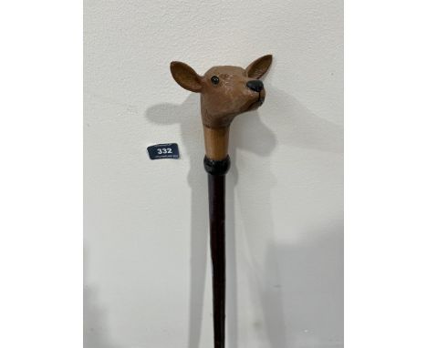 A hazel walking stick, the pommel hand carved as a fawn with glass eyes. 51' long