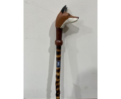 A walking stick, the carved fox head handle with glass eyes. 50' long