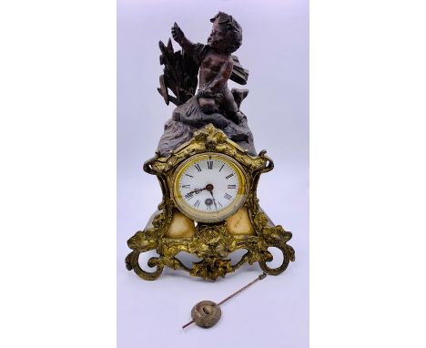 A Mantle clock with Cherubic figure, gilt and marble surround.