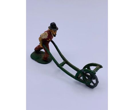 A Timpo 1950's lead Farmer smoking a pipe and pushing a cultivator.