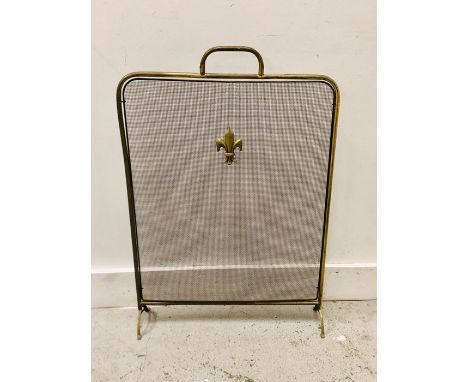 A Brass fire screen with central fleur de lys