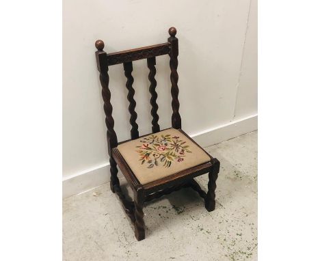 A small carved oak chair with Barley twist legs and back and a floral tapestry seat 