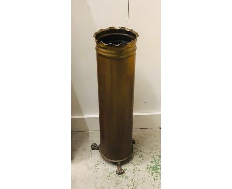 A shell case Umbrella or stick stand on claw feet.