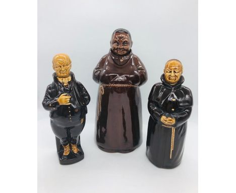 Three treacle glazed decanter figures of which two are monks