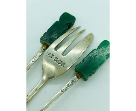 Two silver spoons and a fork.